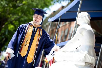 An undergraduate places his had on Joney on the Stoney as he leaves the Commencement stage.
