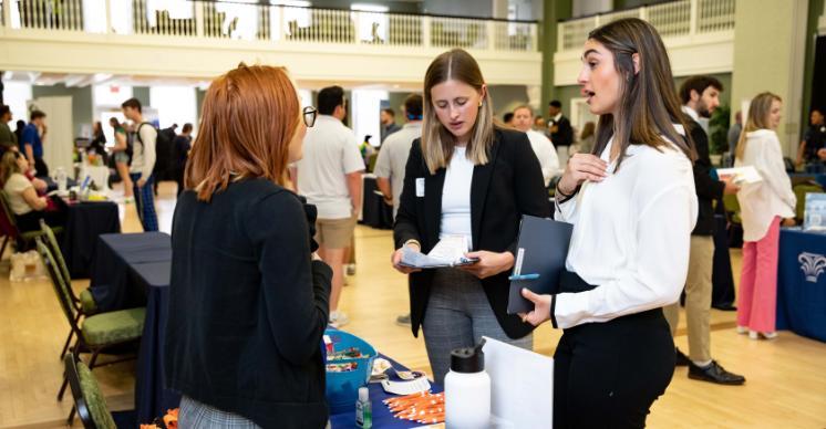 Students speaking to an employer at a career fair