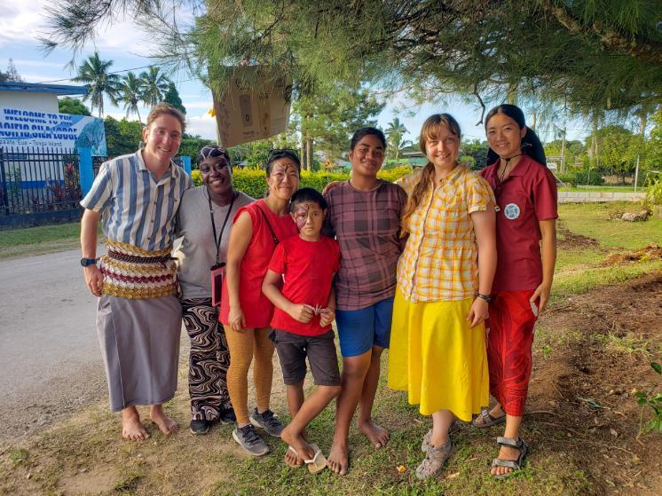 Taylor Bauer '20, M.S. '21 (second from right) stands with Tongan friends, neighbors and fellow Peace Corps volunteers she's met during her time on the island of 'Eua.